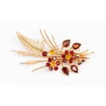 A garnet and citrine set stylized spray brooch,