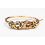 A Victorian 9ct gold double headed snake bangle, set with diamonds and turquoise type stones,