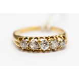 A diamond five stone 18ct gold set boat head ring, graduated diamonds claw set, size L,