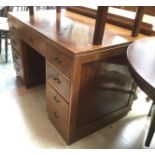 An early 20th Century oak kneehole desk fitted with six short drawers ,