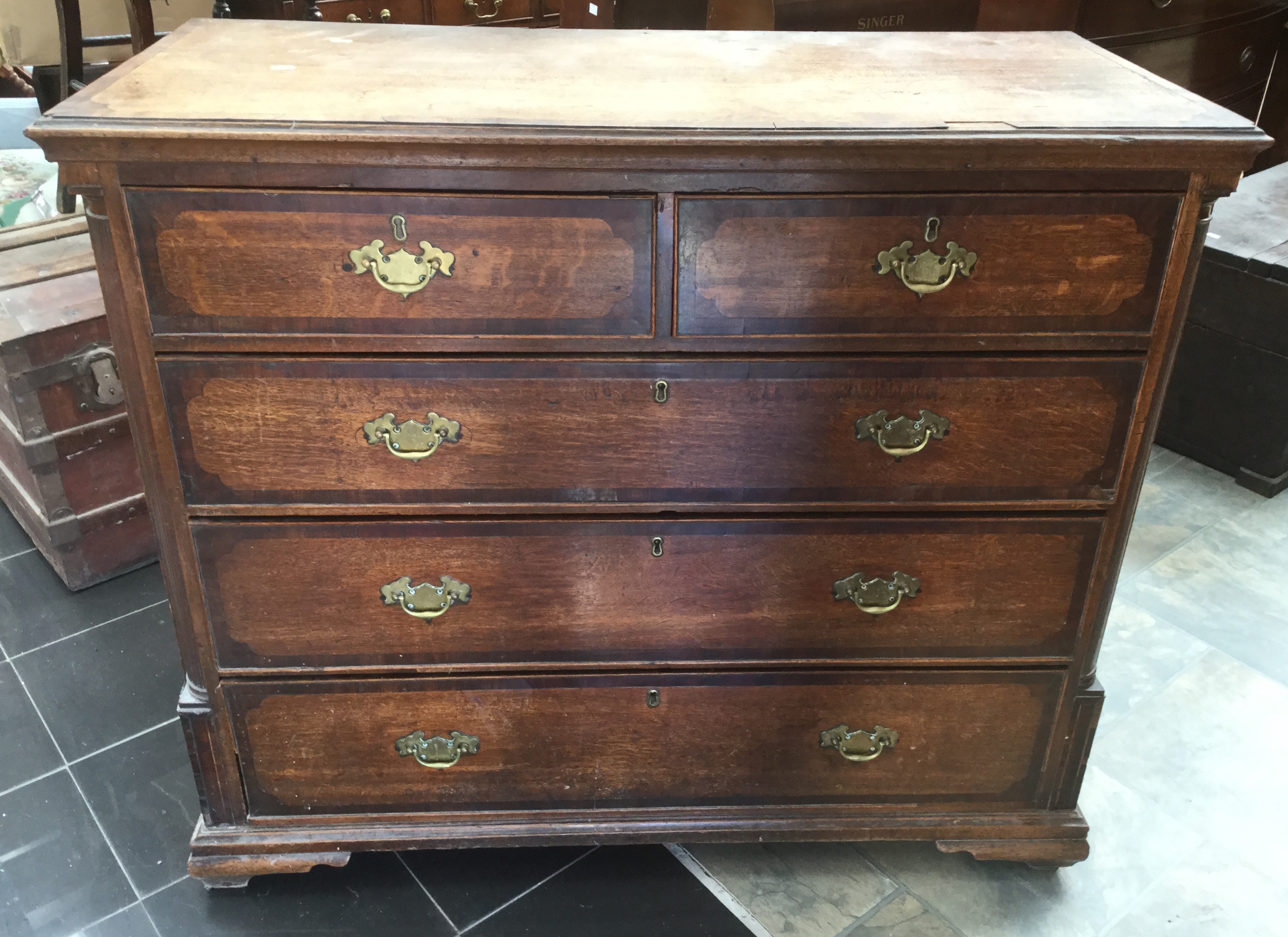 A George III chest of drawers , two short over three long drawers.