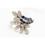 A diamond and sapphire fancy cluster,18ct white gold ring, stylized leaf and scroll design,
