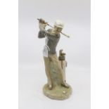 A Lladro china figure of a golfer,