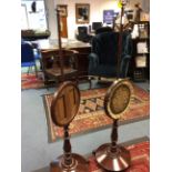 A pair of early 19th Century mahogany pole screen, one with an embroidered panel,