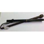 A leather covered riding crop with weighted end and strap. Overall length 46cm.