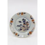 An 18th Century porcelain plate decorated in an Oriental style with cobalt blue and iron red,