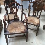 A set of three George III oak rush seated chairs, including one carver.