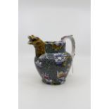 A late 19th Century water jug, transfer printed and painted with profuse foliage, butterflies,