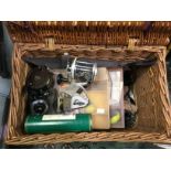 Angling interest: a Wicker fishing basket with floats, reels etc.