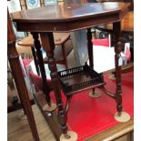 An Edwardian mahogany two-tier occasional table, raised on turned legs,