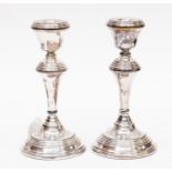 A pair of silver weighted candlesticks (2)