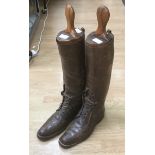 Pair of long leather riding boots. Size 7. includes boot stretchers.