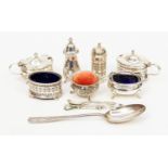 Two silver three-piece cruet sets: one Georgian style with pierced and engraved decoration,
