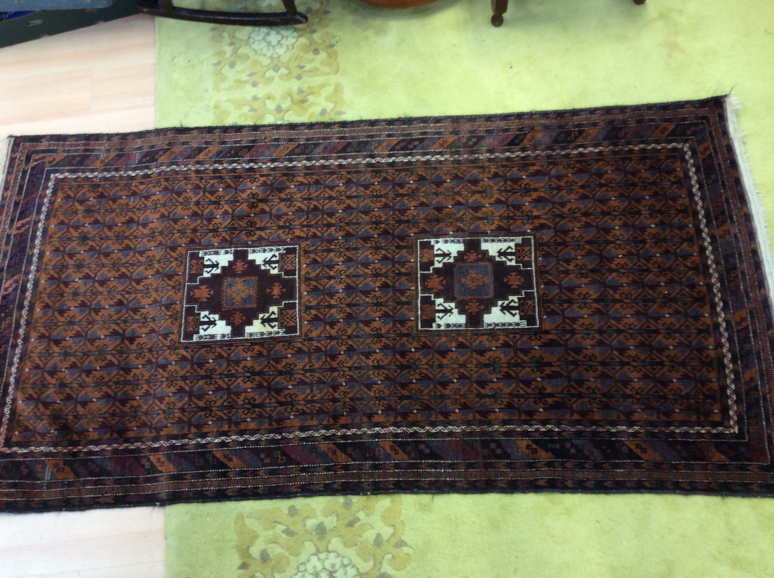 A 20th Century carpet, geometric design in rust coloured hues,