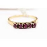 An 18 ct gold 5 small ruby set ring