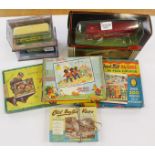 Four vintage jigsaw puzzles and four boxed model buses,