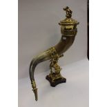 A 19th Century ceremonial sporting trophy hunting horn, brass cover and mounts, on an oak plinth,
