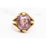 An amethyst and unmarked 18ct gold amethyst set signet ring, size O1/2,