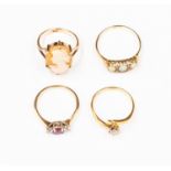 A collection of four rings including a diamond solitaire set in 18ct gold, size N1/2,