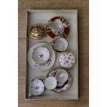 A selection of fine china to include a pair of Meissen tea cups with floral design,