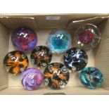 A collection of nine Caithness glass company paperweights including Diabolo;