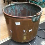 A large copper coal bucket.