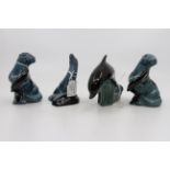 A collection of four Poole Pottery sea lions and dolphins