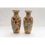 A pair of late 19th Century Meiji period (1868-1912) Satsuma ware baluster vases, one damaged,