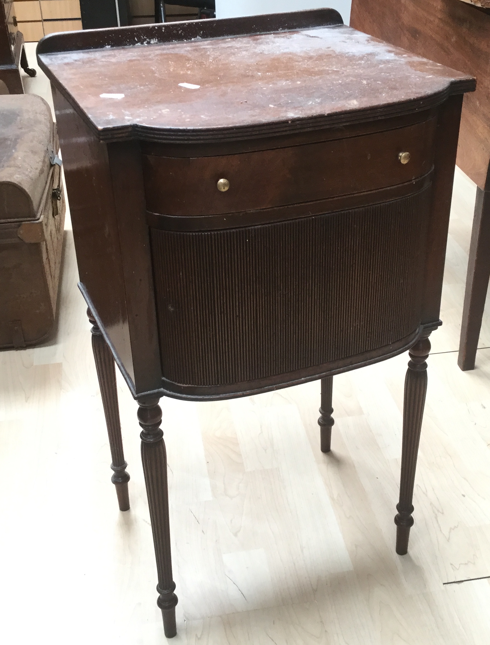 A canework topped table together with a mahogany bedside table.