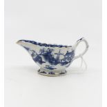 An 18th Century English porcelain blue and white oval small sauce boat decorated landscape building