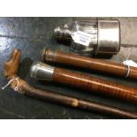 Three walking sticks: one with silver mounted top engraved with initials,