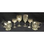 Assorted etched glassware including two small wine glasses with vine detail,