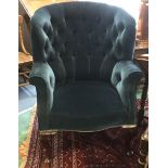 An early 20th Century blue upholstered deep button wing backed chair, traditionally upholstered,