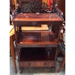 A Victorian three tier mahogany whatnot with carved fretwork.