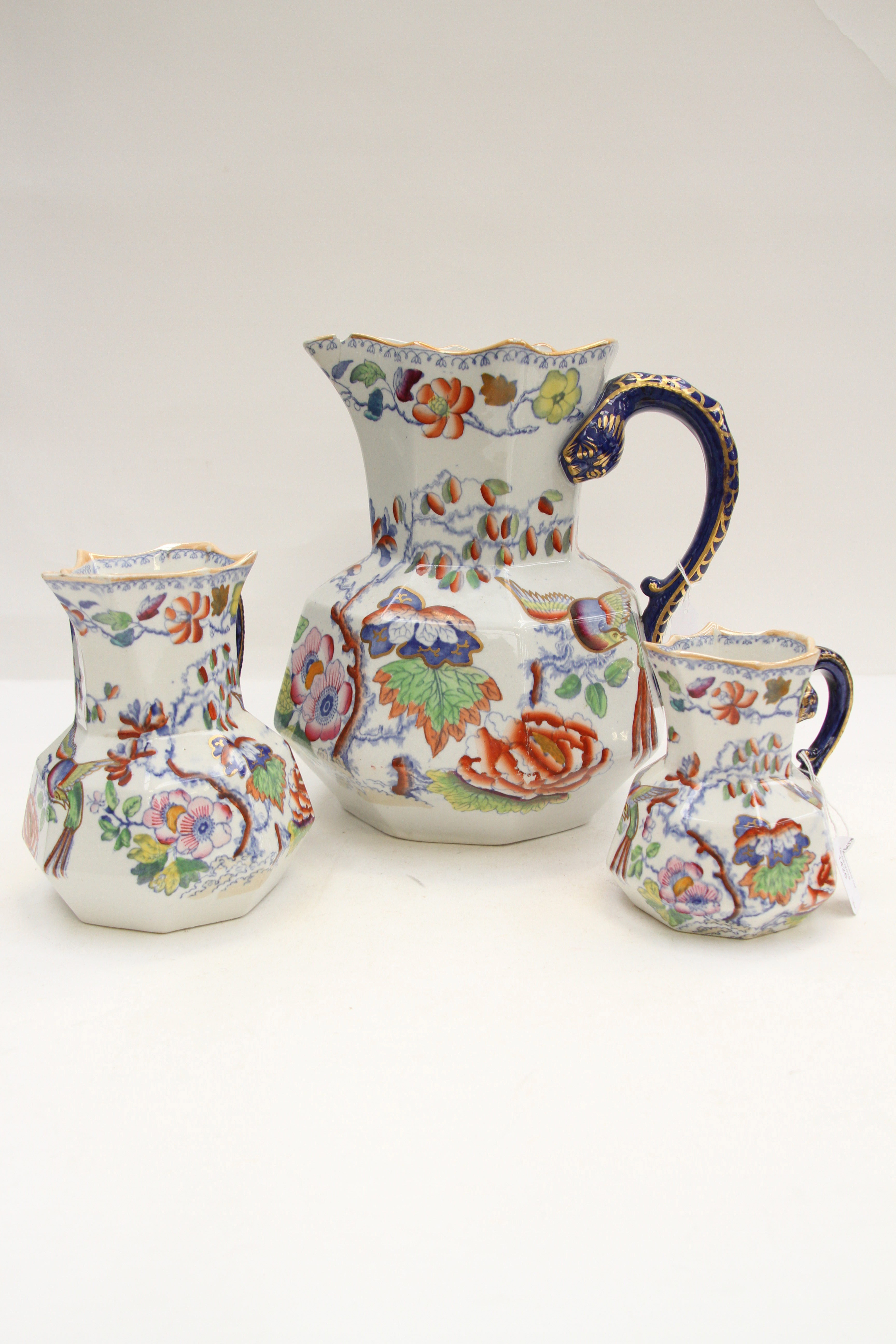 A set of three Mason's hand finished graduated jugs,