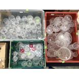 A large quantity of cut and moulded glass including vases, sundae dishes,