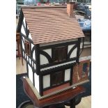 A 20th Century doll's house, modelled as a half timbered mock Tudor house,