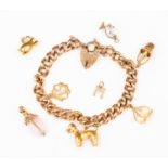 A 9ct gold charm bracelet with various 9ct gold and yellow metal charms including a poodle and urn