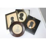 Three oval silhouette portrait minatures,together with a circular pencil portrait of a young boy.