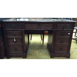 A traditional oak twin pedestal writing desk, the upper section with three drawers,