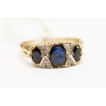A sapphire and diamond boat head 9ct gold ring,