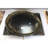 A lacquered papier mache tray with mother of pearl inlays depicting an Oriental scene,