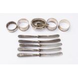 Four silver napkin rings, five silver handled butter knives, mustard pot and spoon,