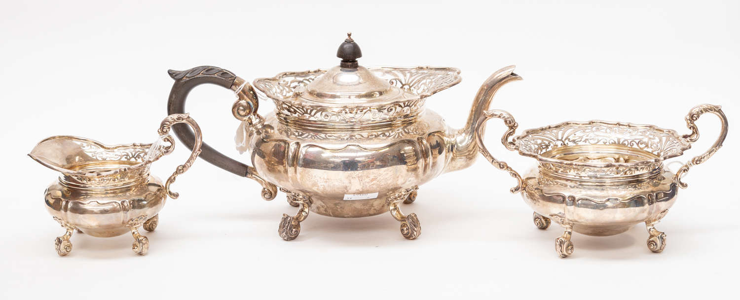 An Edwardian silver three piece tea service comprising teapot, sugar bowl and milk jug,