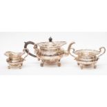 An Edwardian silver three piece tea service comprising teapot, sugar bowl and milk jug,