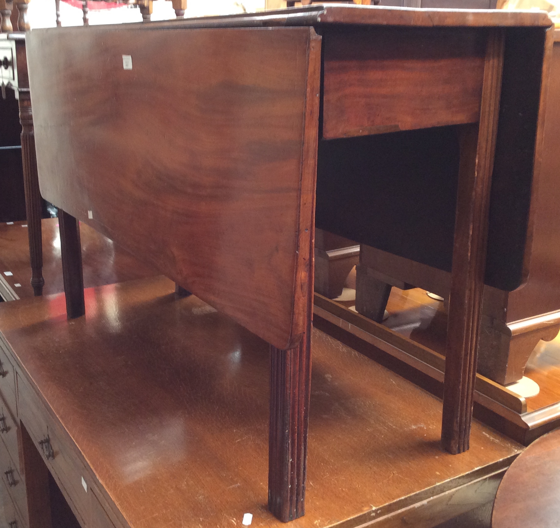 A 19th Century mahogany dropleaf table.