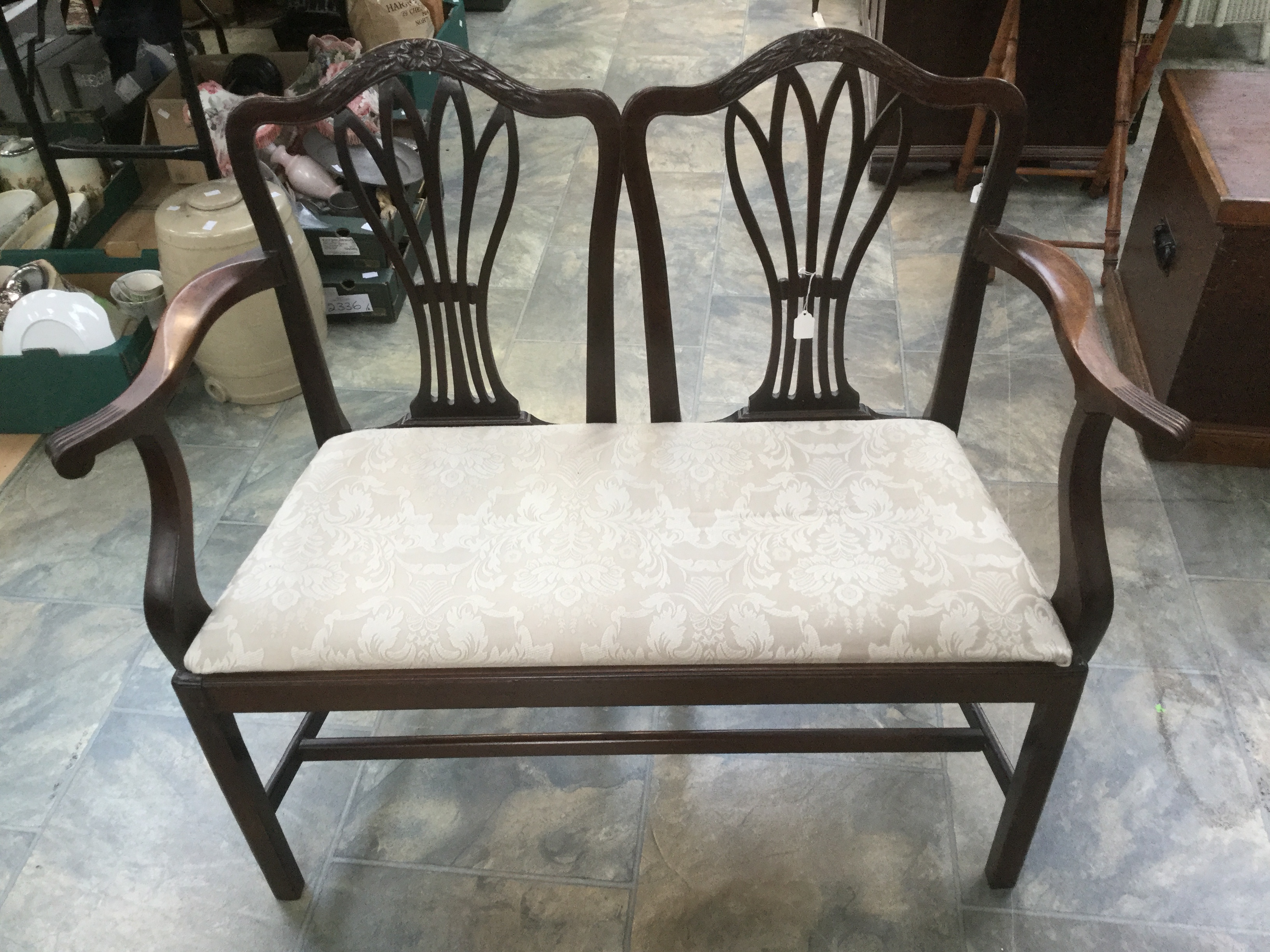 A 19th Century mahogany chair back settee, of camel back form, drop in seat, 90 cms high,