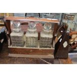 Mid 20th Century tantalus, three decanters with stoppers and key,