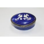 A Bilston cobalt blue enamel snuff box with raised pattern of two love birds in white.