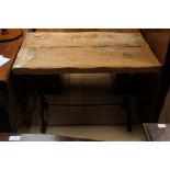 An early 20th Century pine plank top wrought iron table,